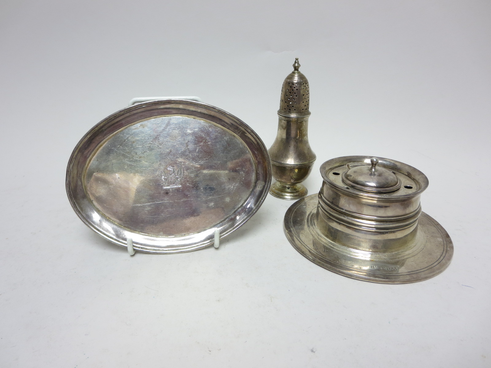 A George III silver oval Teapot Stand engraved crest, London 1806, a Sifter, London 1774 and a