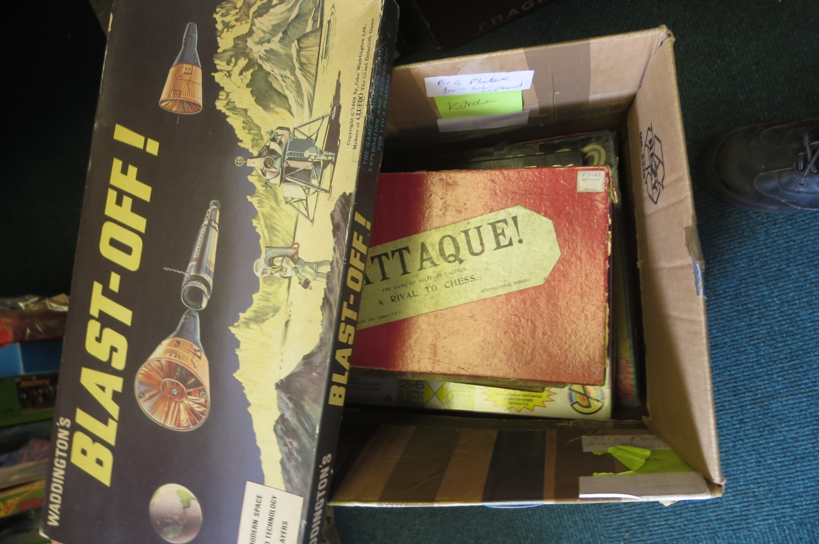 A box of board games including Waddingtons ‘Blast Off’, ‘L’Attaque!’, ‘PM’, ‘Captain Scarlet