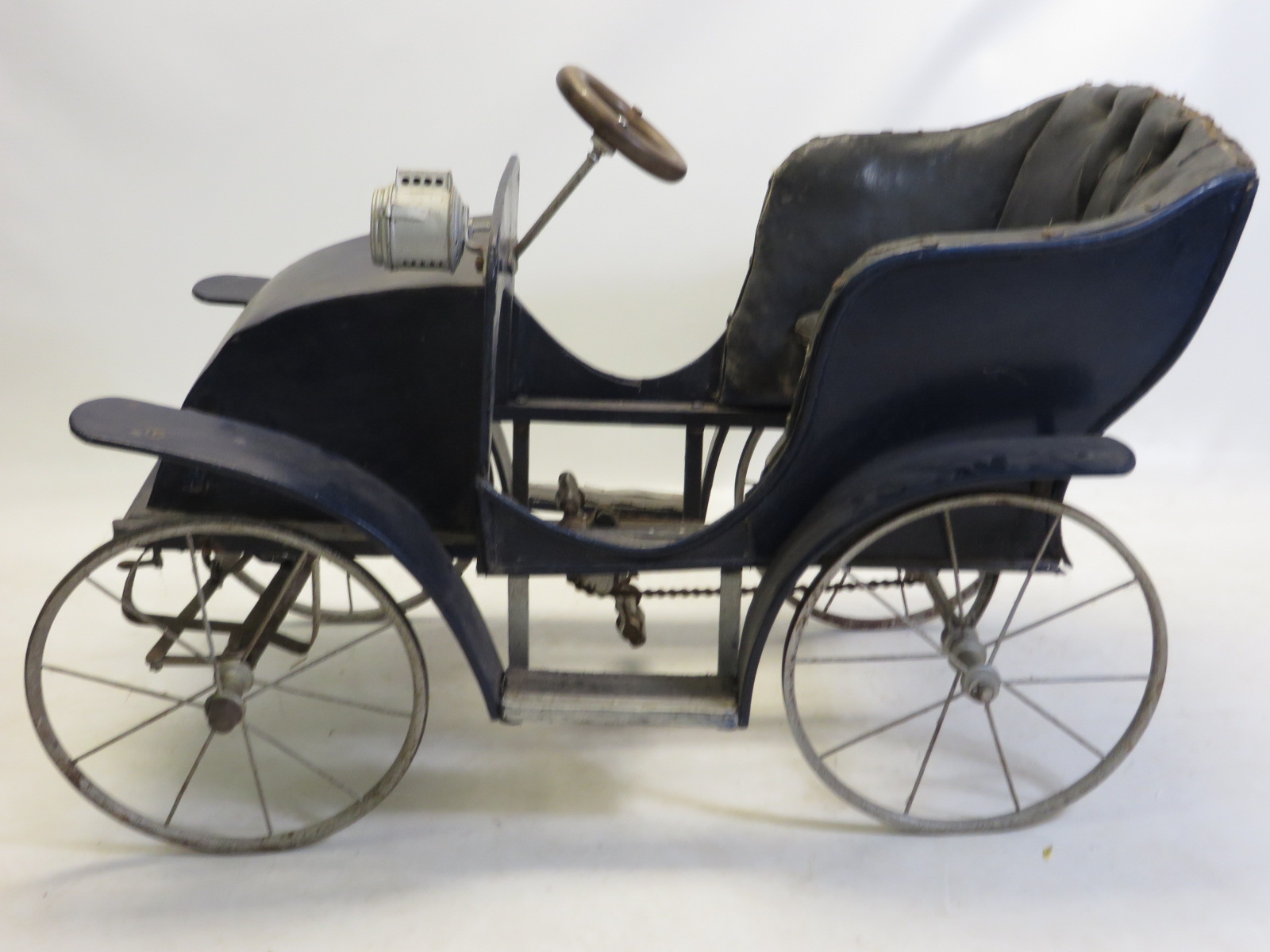 An early G & J Lines blue Gordon Bennett type pedal car with deep buttoned seats and wire wheels.