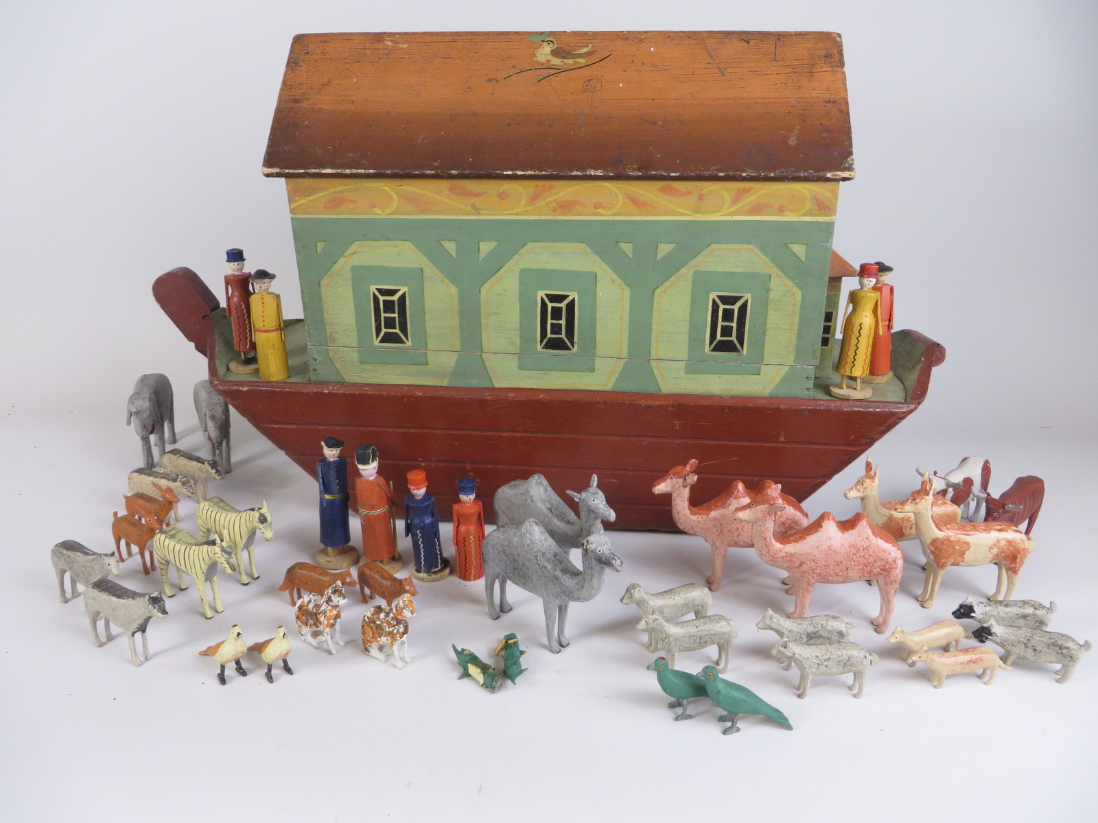 A fine German made mid 19th century Noah’s Ark with hull and hinged roof painted with a bird.