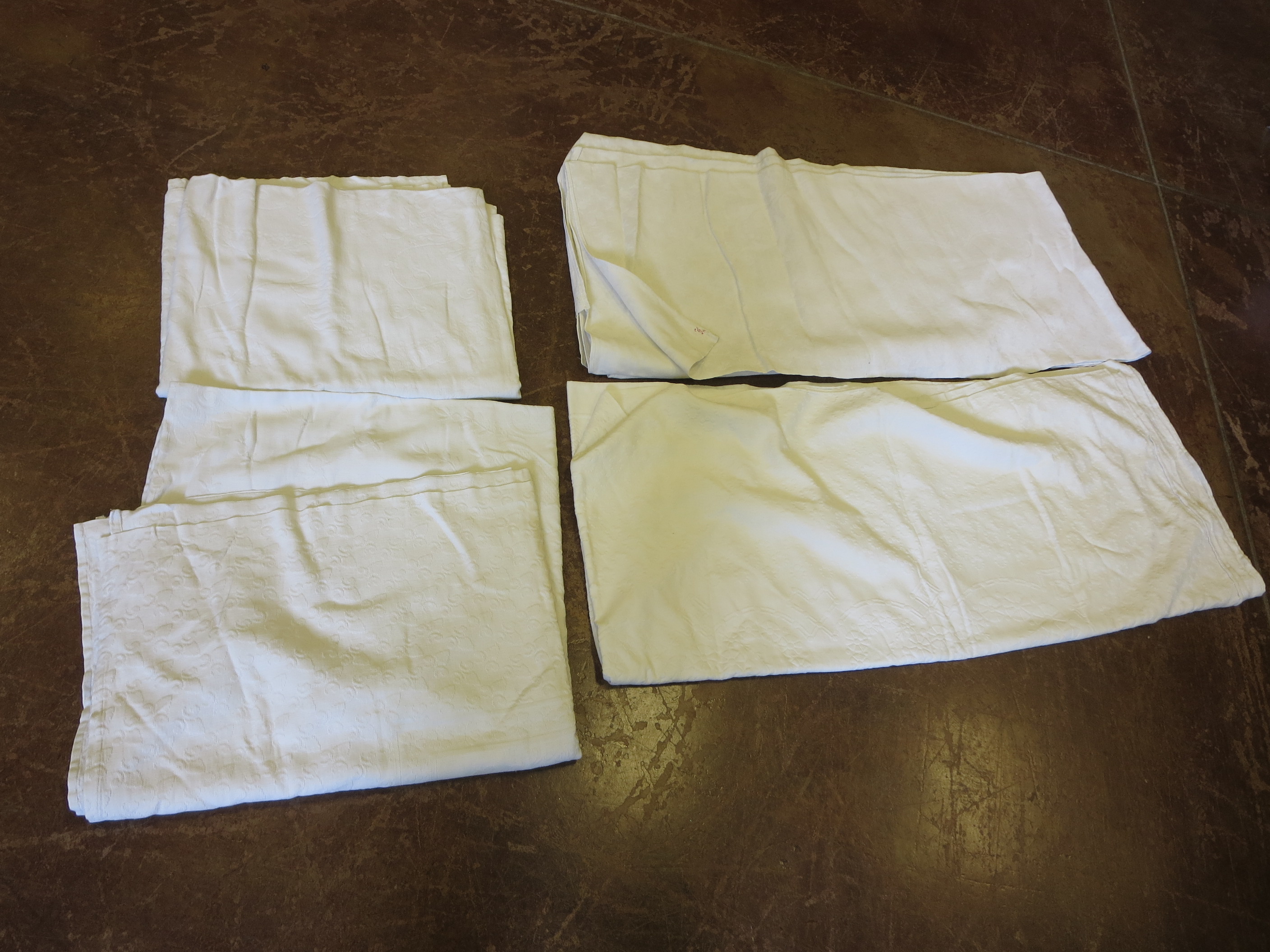 Four embossed white cotton bedcovers