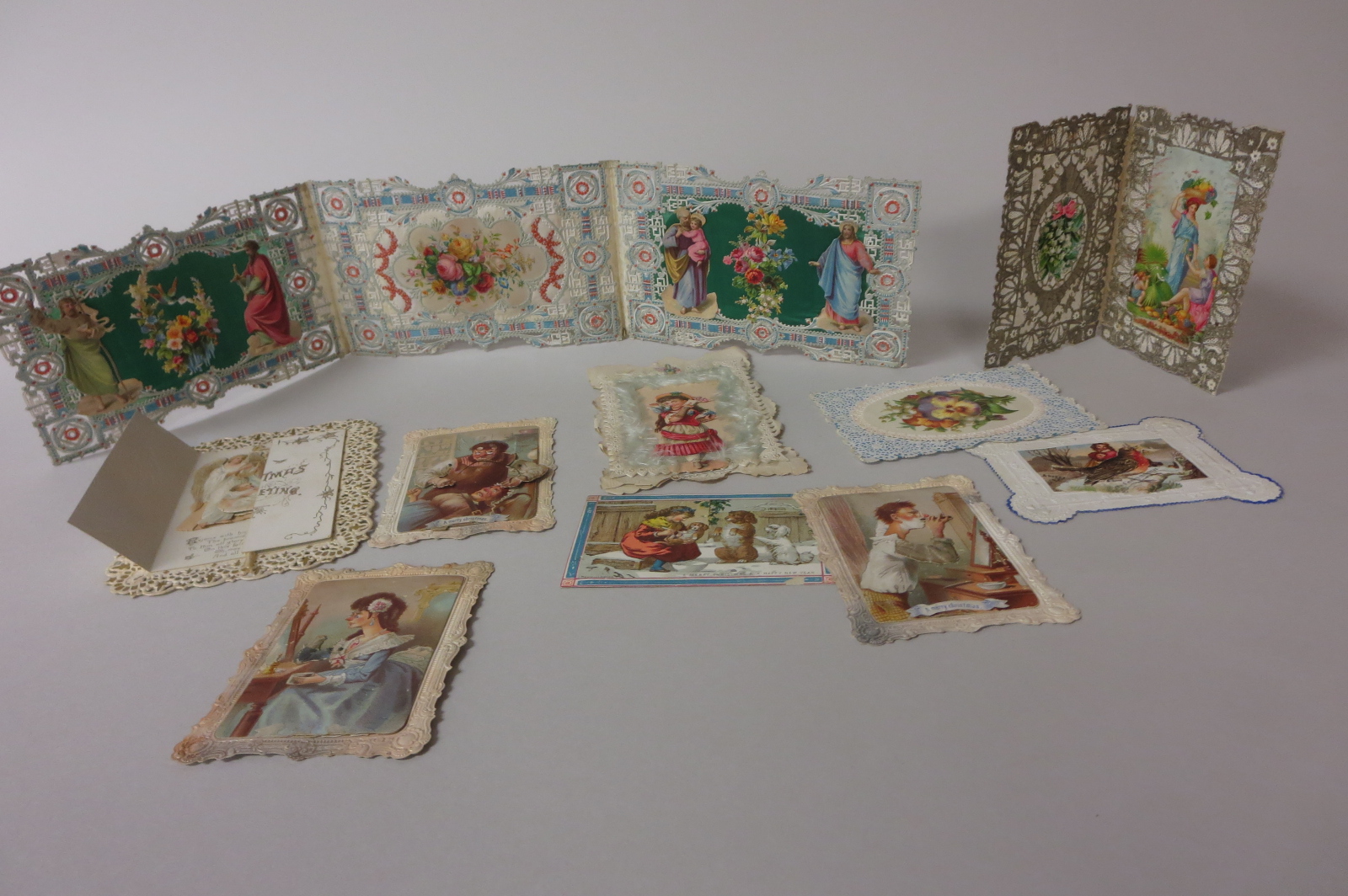 A collection of lace and silk edged cut paper Christmas and Valentine Cards