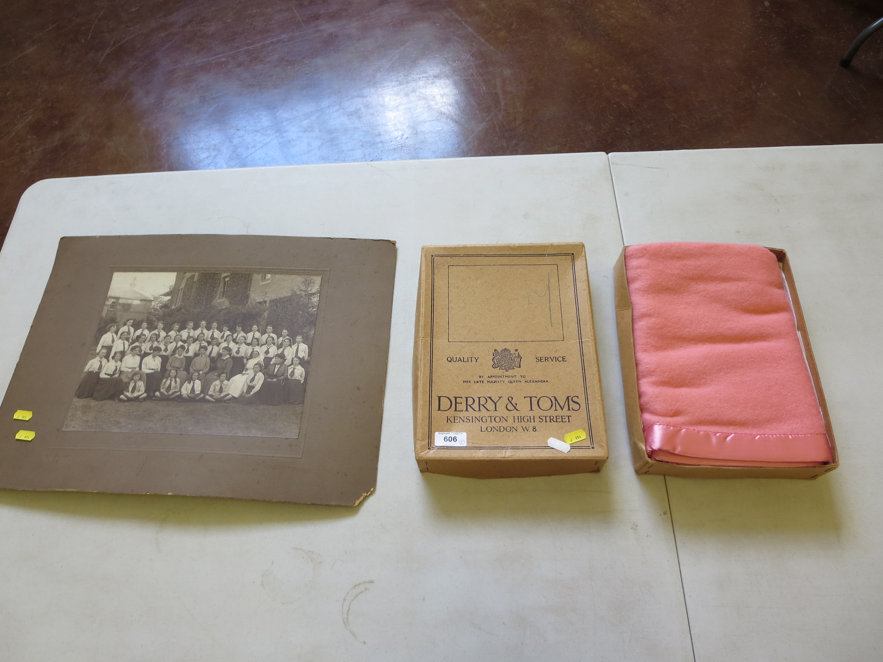 A Derry and Toms of Kensington boxed pink cot blanket and a girls school photograph