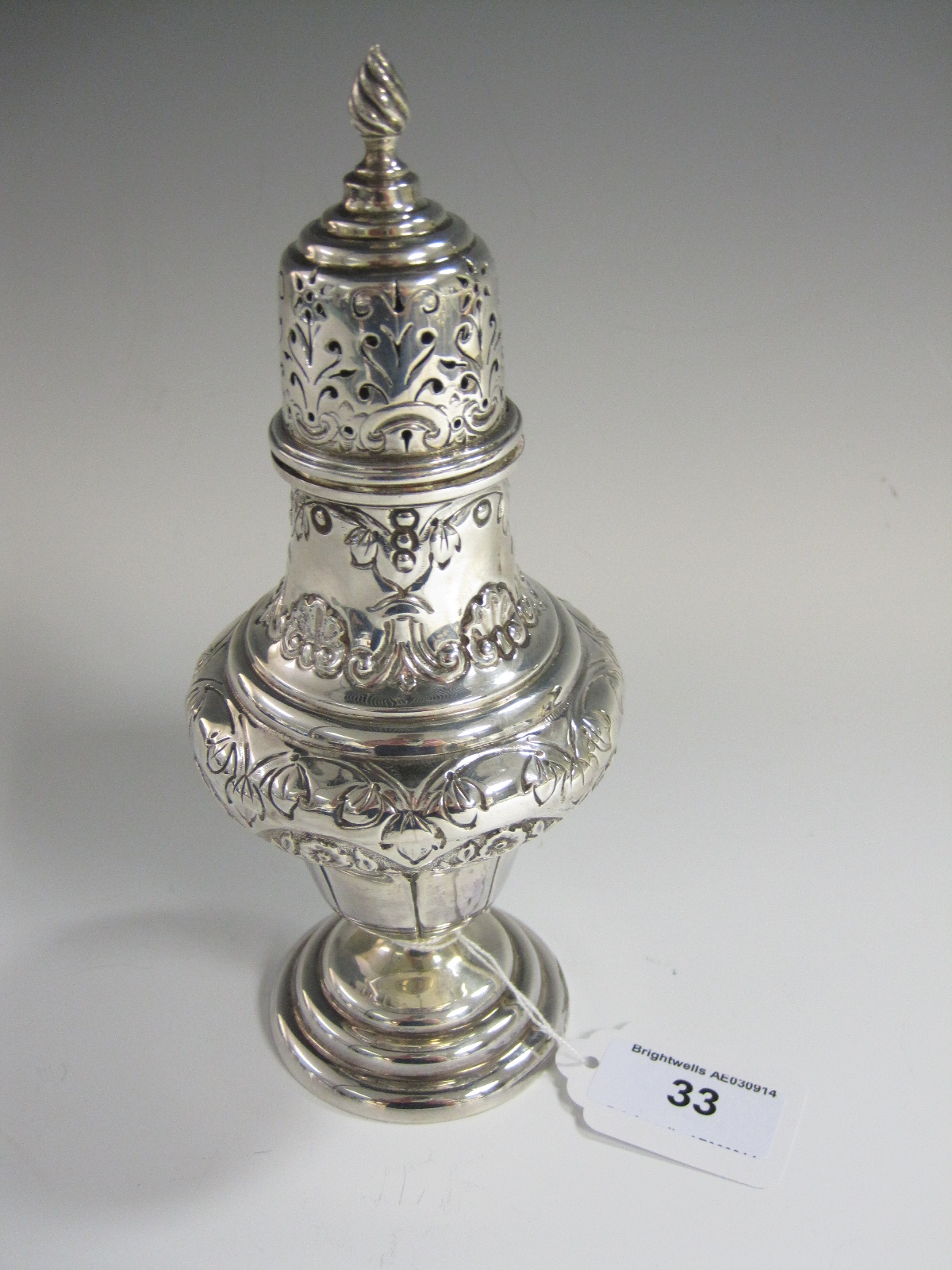 An Edward VII silver Sugar Caster of baluster form with floral embossed decoration, 7in H,