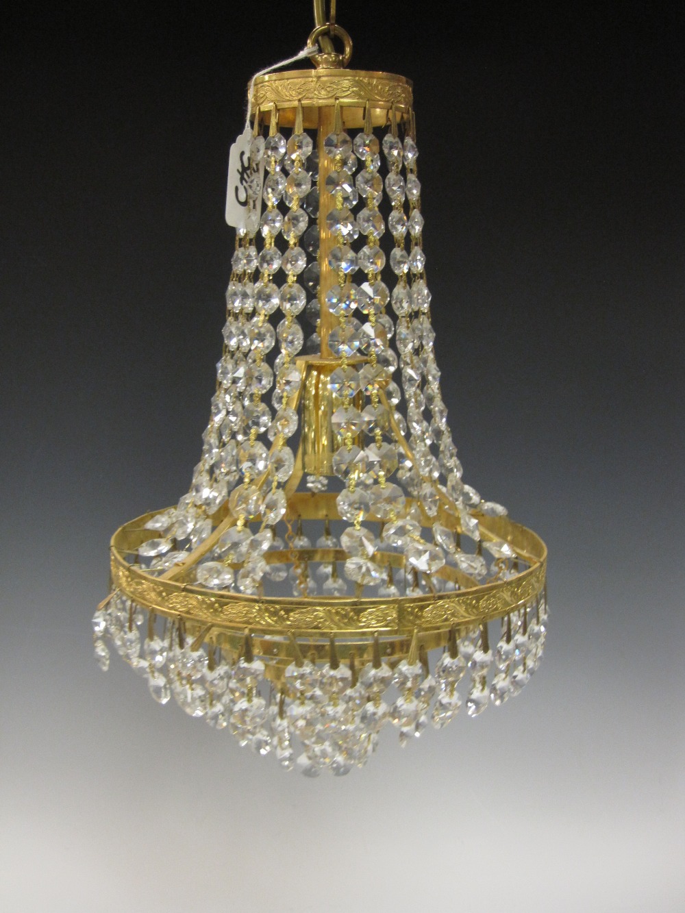 A cut-glass Chandelier with rows of pendant drops on ormolu effect mounts