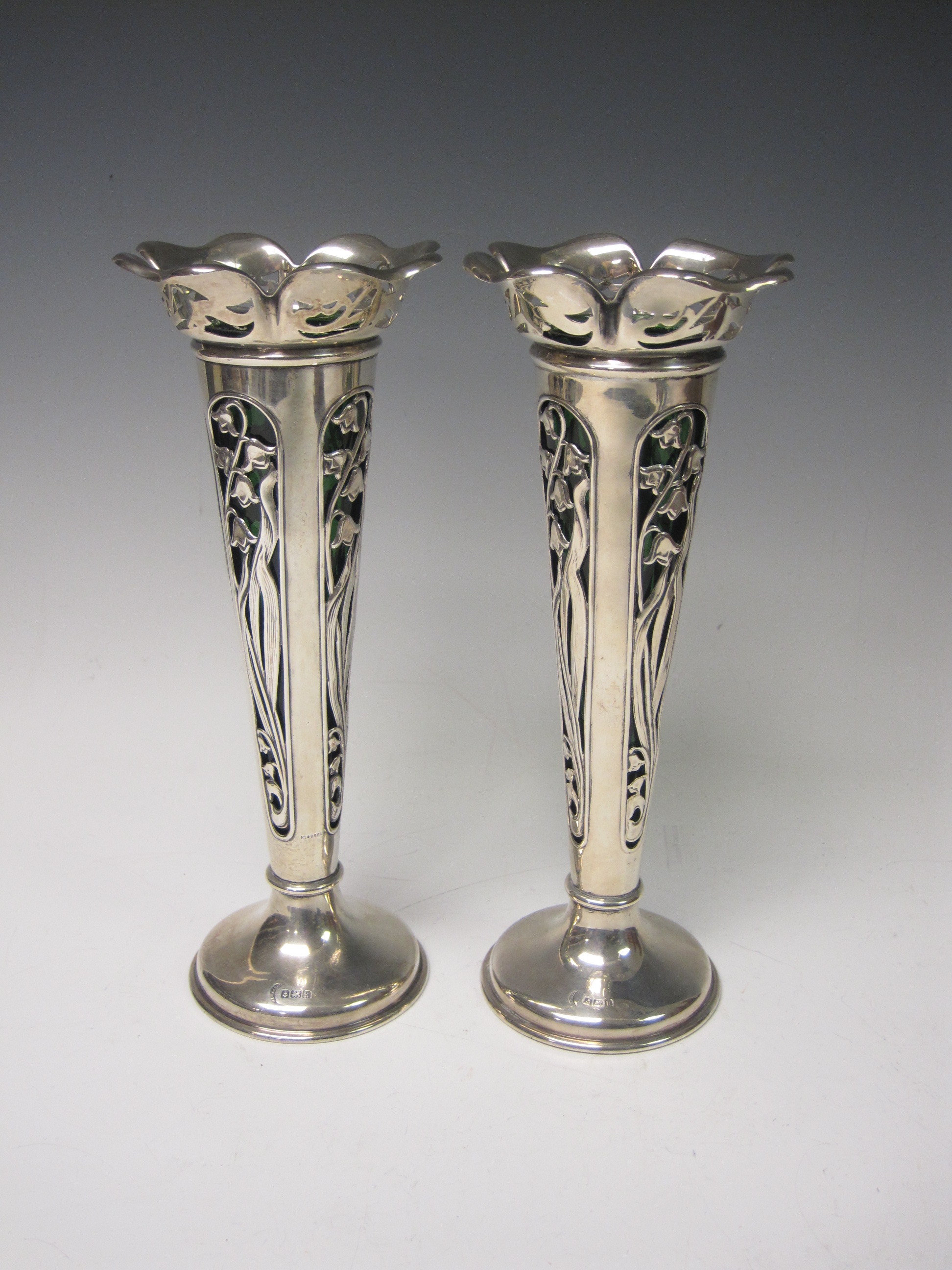 Pair of Edward VII Art Nouveau silver Vases with pierced harebell pattern and green glass liners,