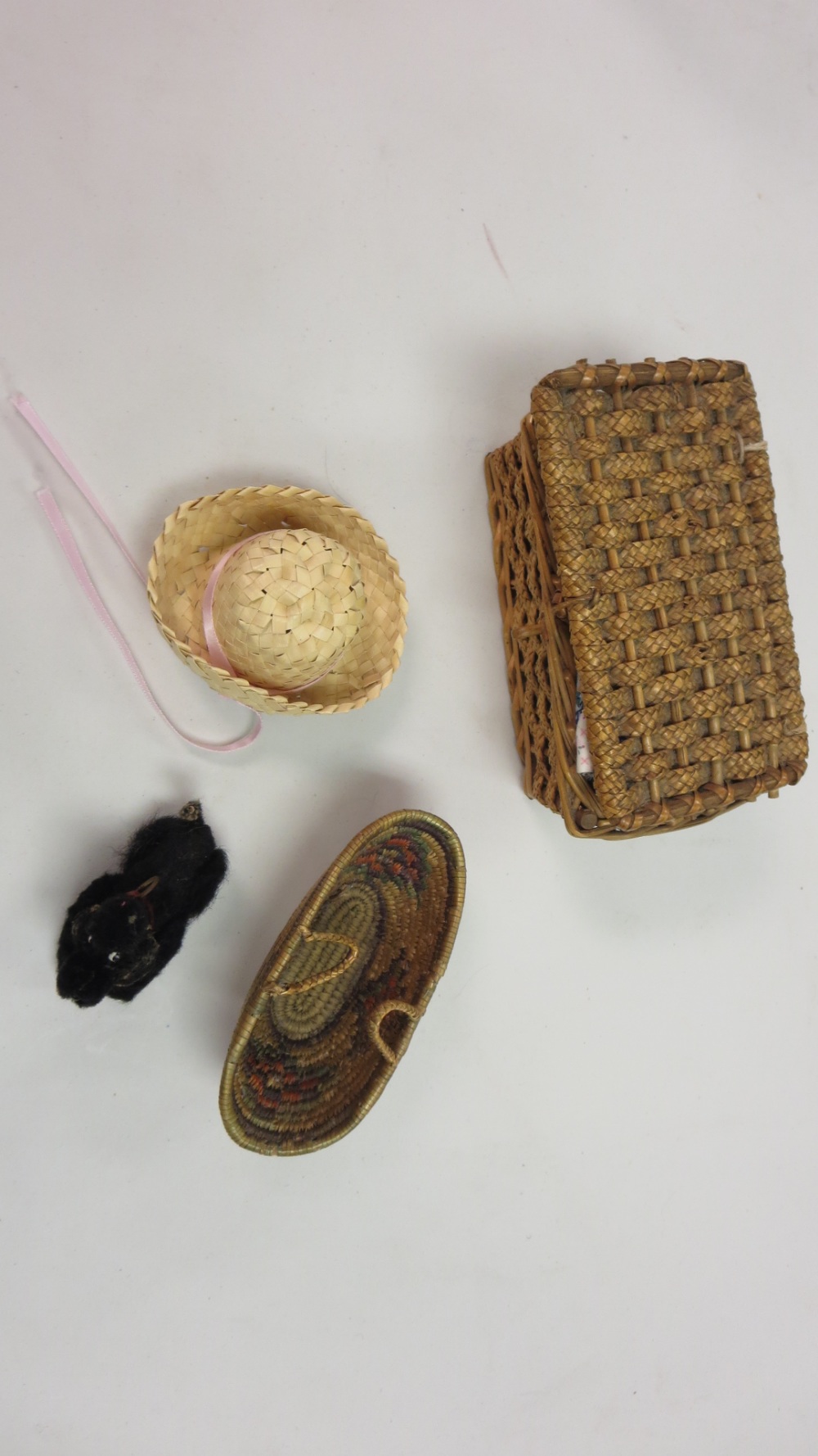 A doll`s wicker picnic basket, another basket and an old poodle