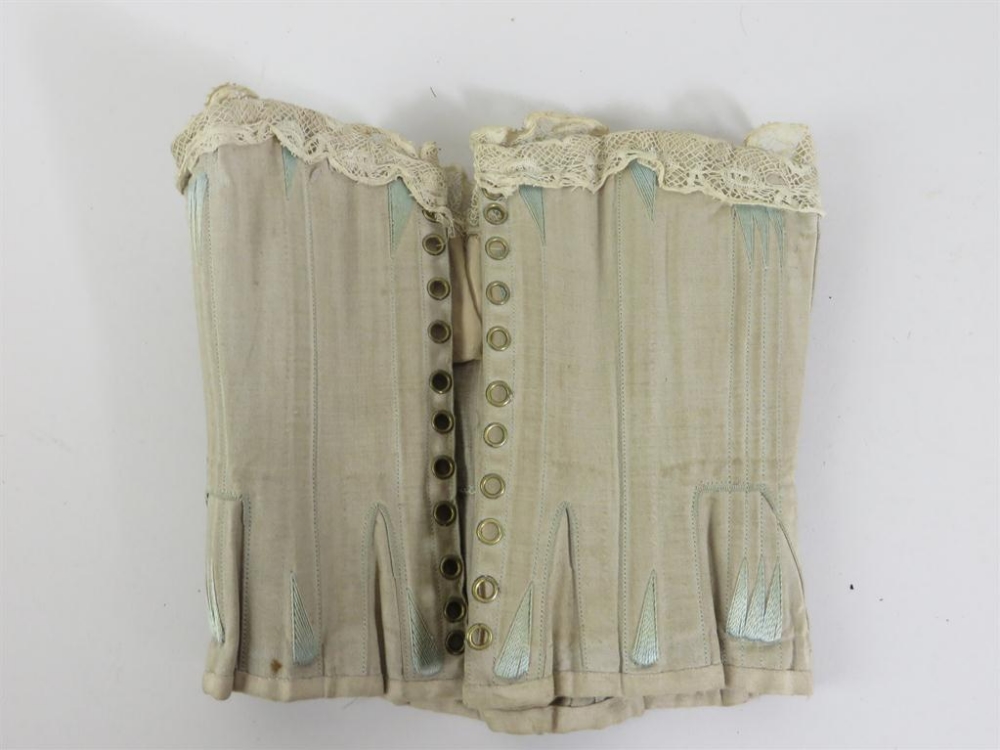 A correctly made miniature corset suitable for bebe or large fashion doll. Pale turquoise with