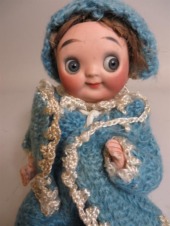 A bisque headed lever eyed googlie doll with closed mouth and five piece body, original blue and