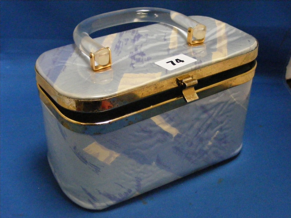 A circa 1960's ladies handbag in plastic covered blue and white material with lucite handle, plus