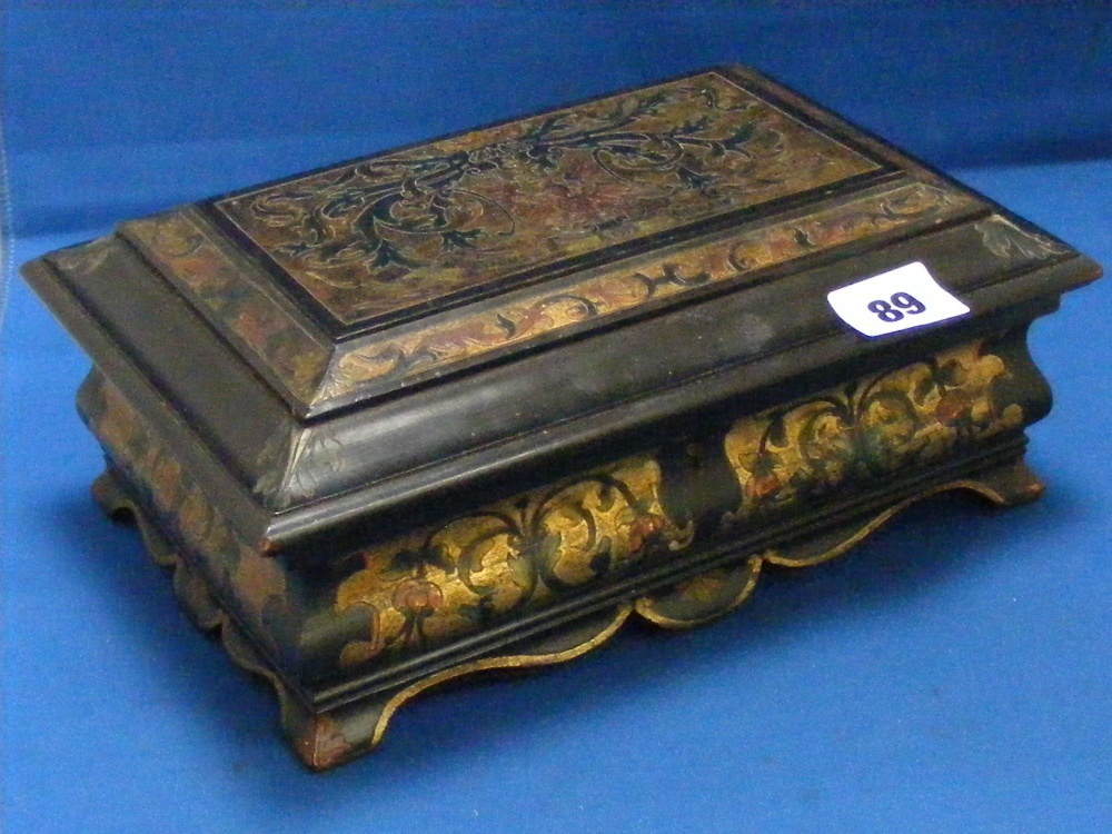 A fine quality antique box of ebonised wood with gilt work decoration and bearing a Coat of Arms