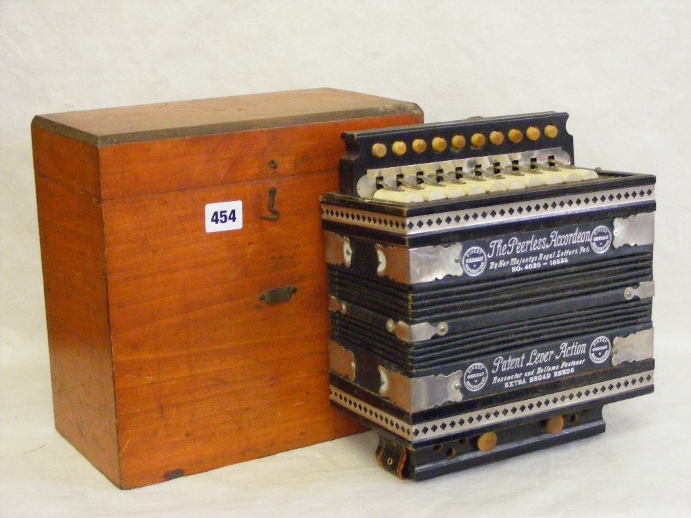 A cased Pearless accordion.