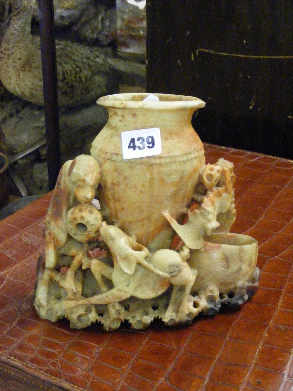 A soapstone spill vase with carved deer and monkeys design.