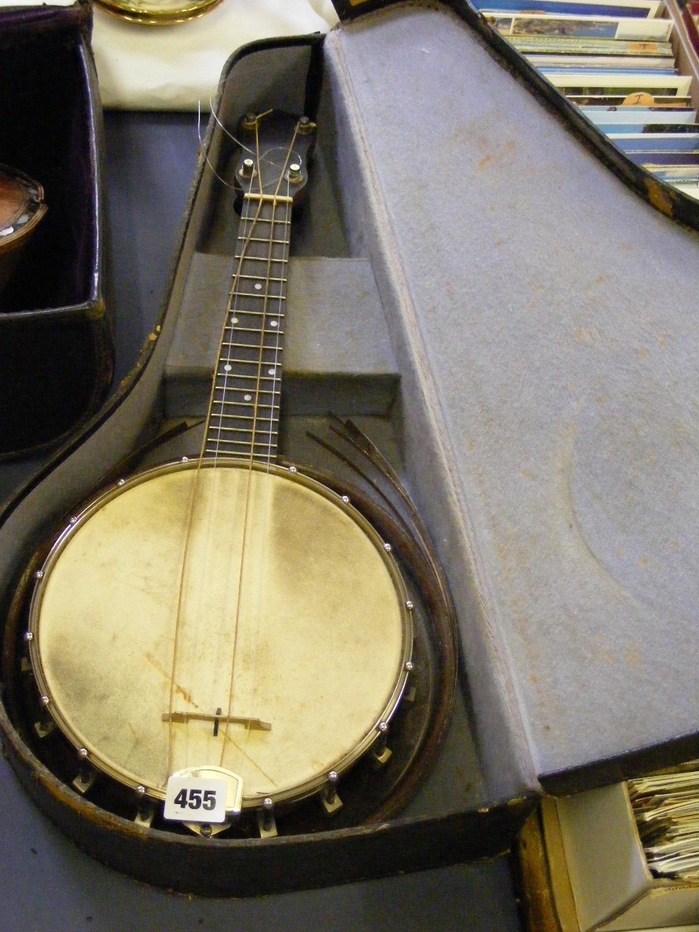 A cased ukulele (for restoration).