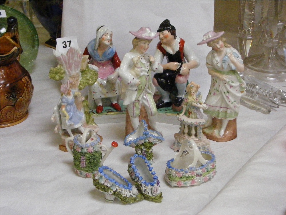 A collection of Staffordshire figures, to include a pair depicting a lady and a gentleman seated and