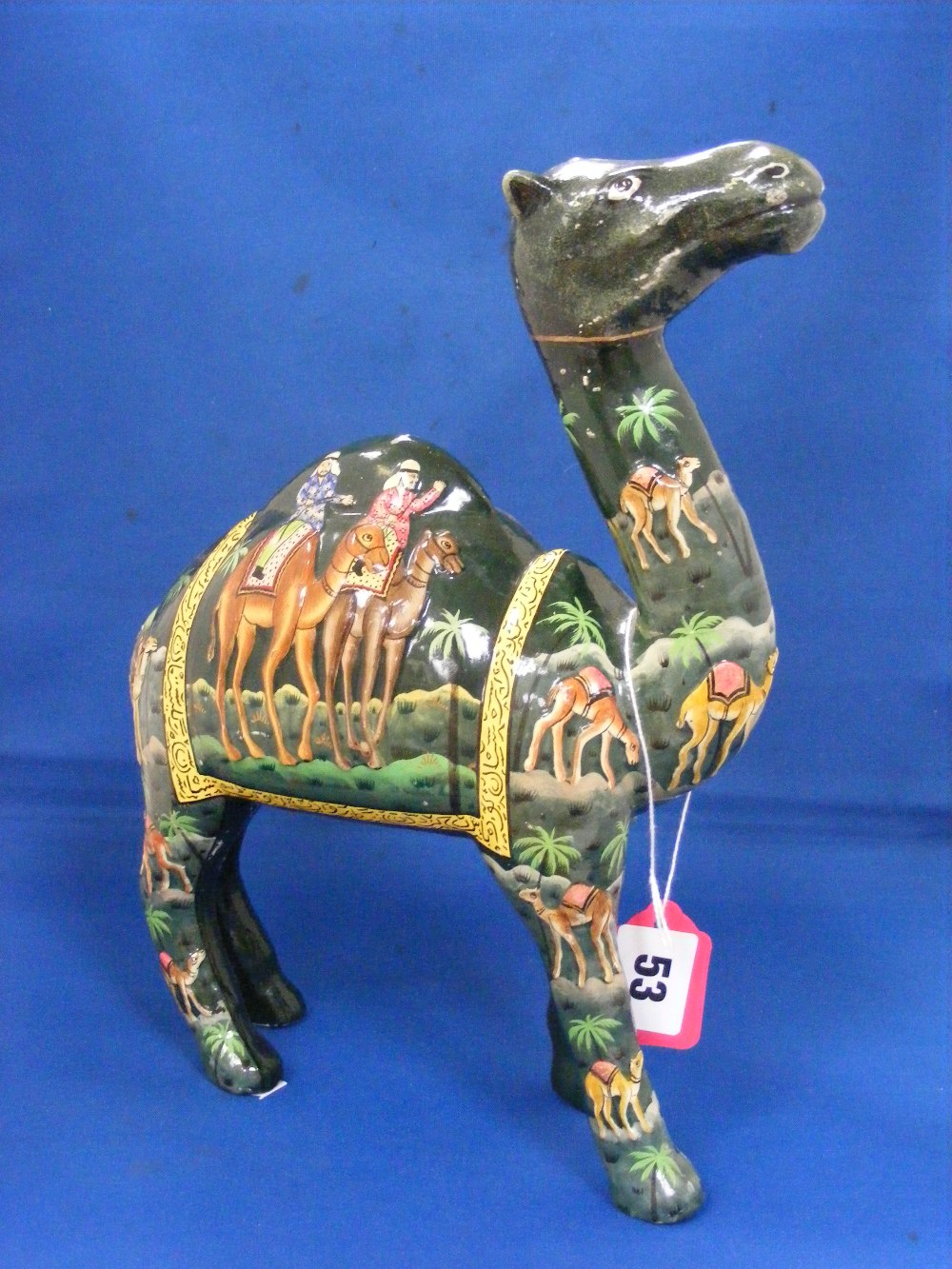 An unusual composition figure of a camel decorated with a variety of Egyptianesque and other