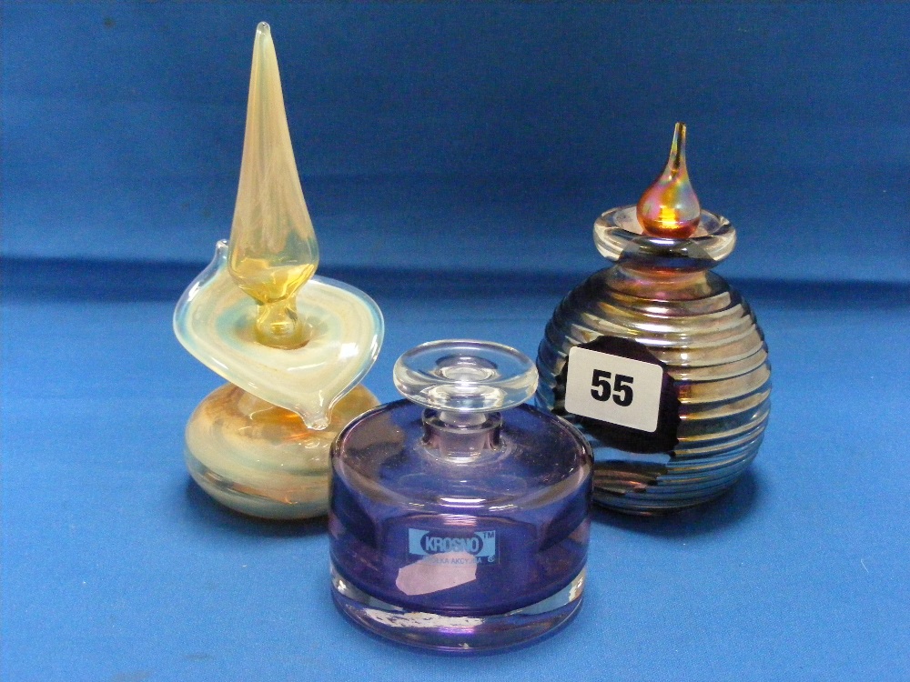 An attractive group of perfume bottles comprising a stylish spherical bottle with ribbed