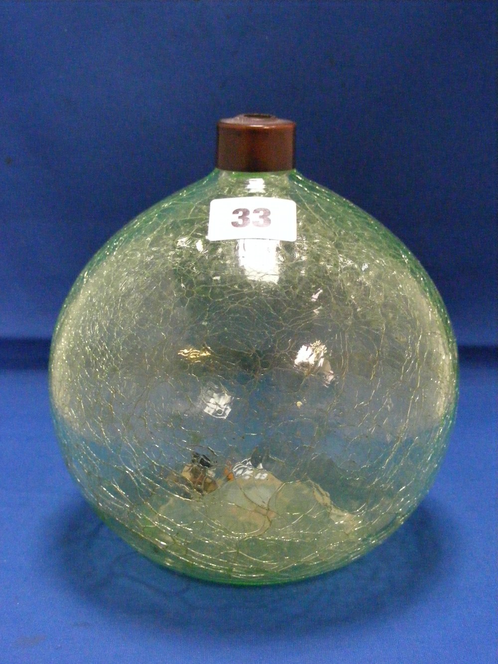 An antique green crackle ware perfume bottle of ovoid form with metal collar. Height 18cms.