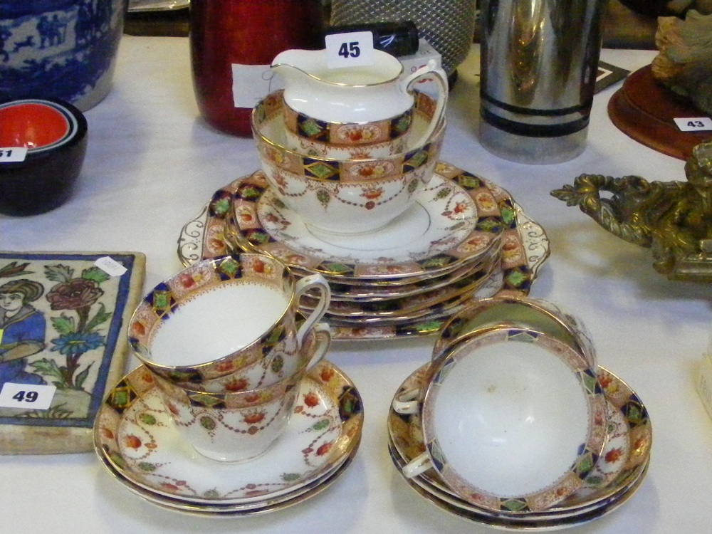 A Longton Doric china part tea service comprising cups, saucers, plates, sugar bowl and milk jug.