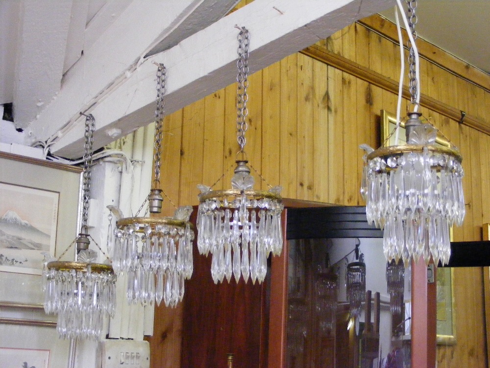 A set of four vintage crystal 2-tier chandeliers.