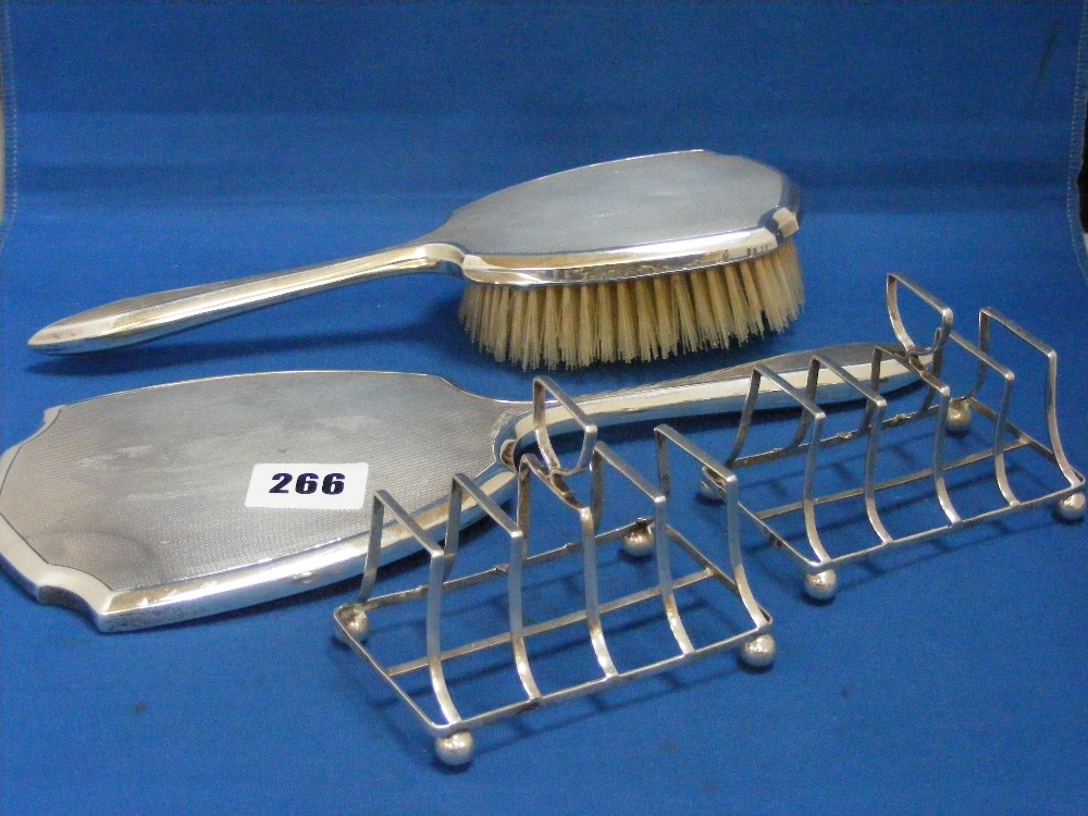A nice silver, 25cms, brush and mirror, plus a pair of silver toast racks, H/M Birmingham 1908.