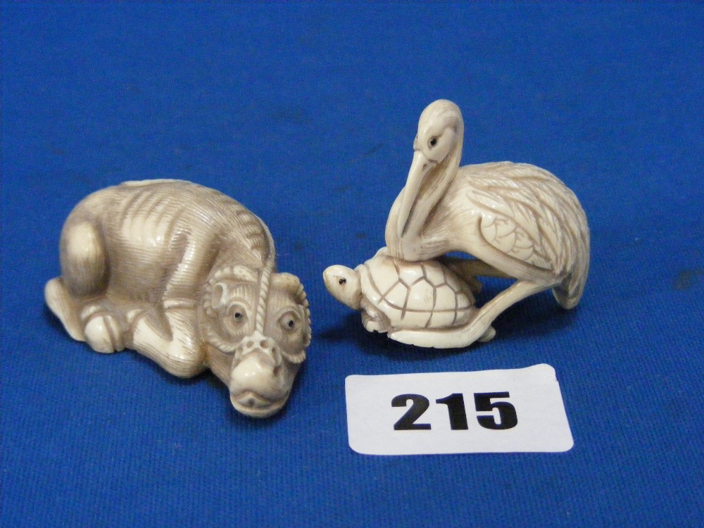 Two Japanese carved ivory Netsuke, one a crane on a tortoise, the other a water buffalo, both