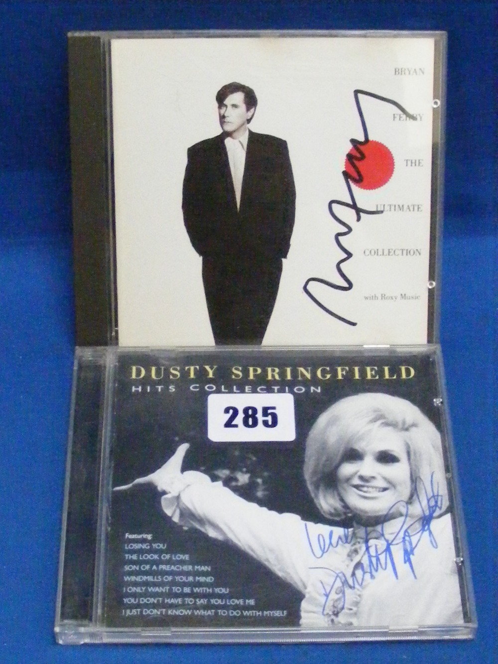 Bryan Ferry/Dusty Springfield.   Two signed C.D.'s, Ferry's Ultimate Collection and Springfield's