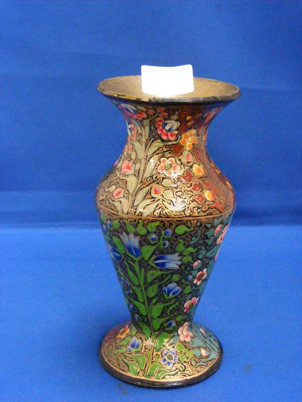 An attractive antique papier-mâché vase of Persian influence painted in multi colours with highly