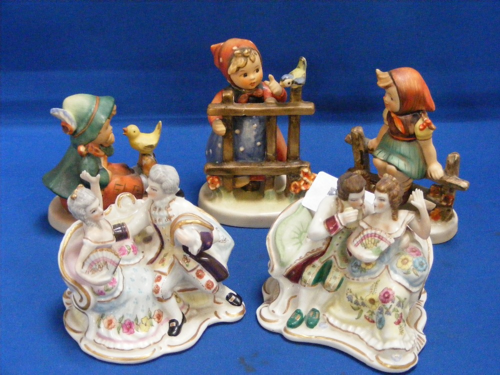 Three Goebel Hummel figurines of children, together with two small Continental porcelain figural