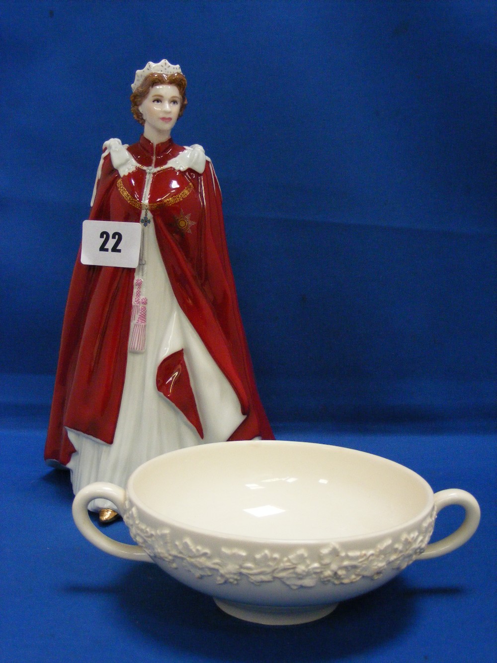 A Royal Worcester figure of Queen Elizabeth II, together with a Wedgwood Queen's ware two handled