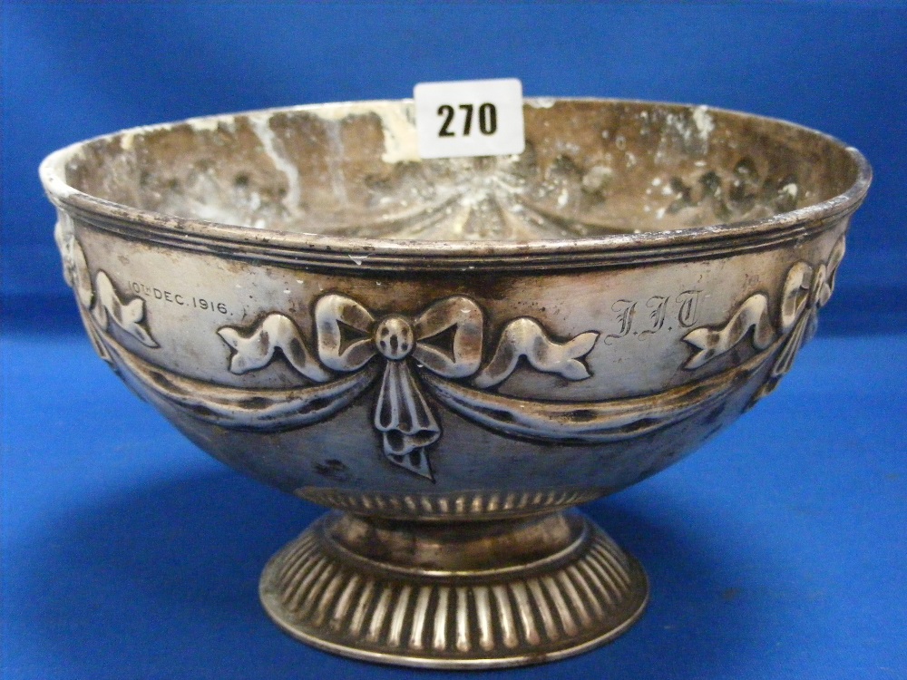 A silver fruit bowl decorated with ribbons and swags on a circular fluted base, H/M Birmingham 1915,