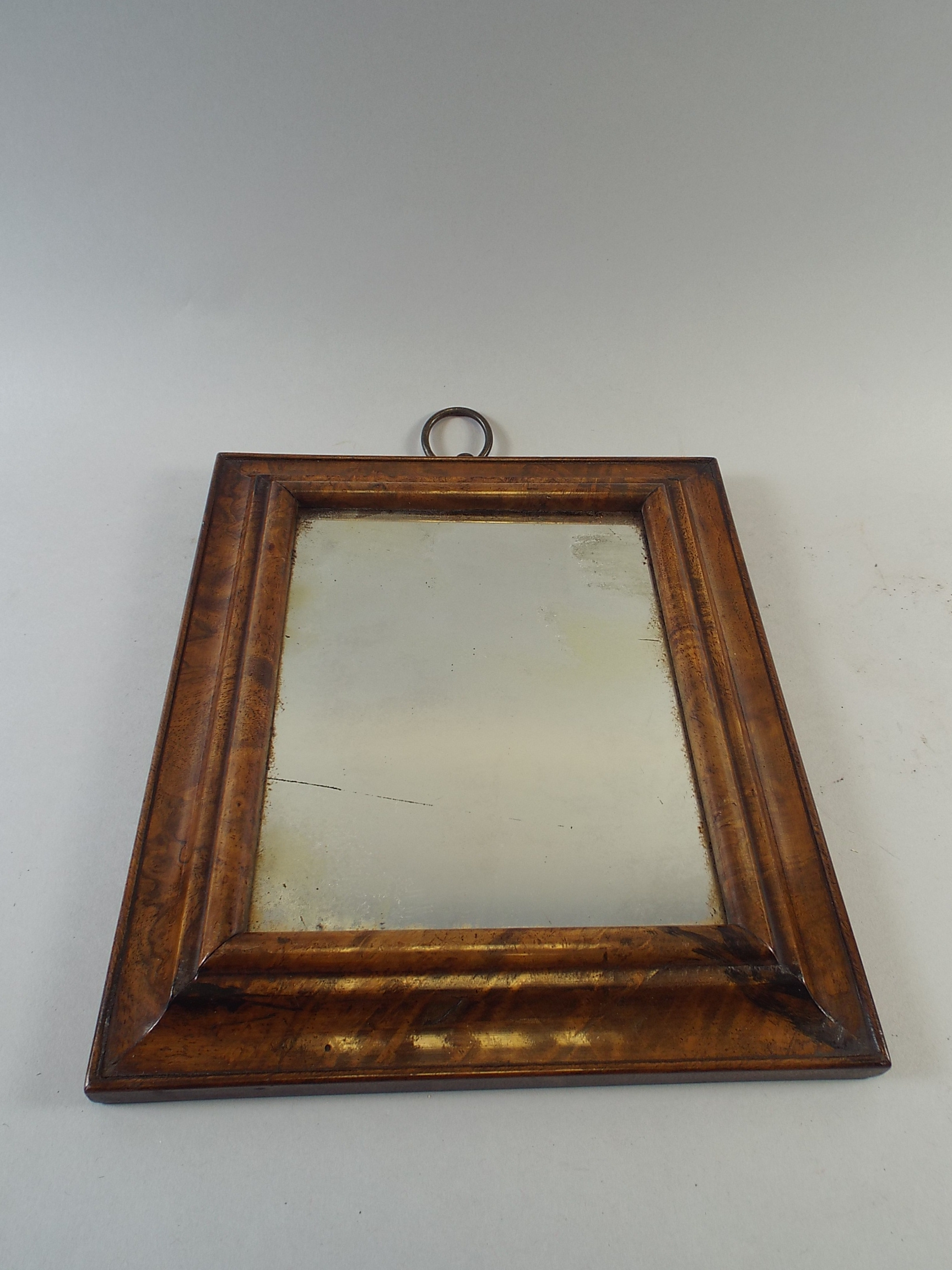 A 19th Century Wall Mirror with a Walnut Veneered Moulded Frame. 24x21cm