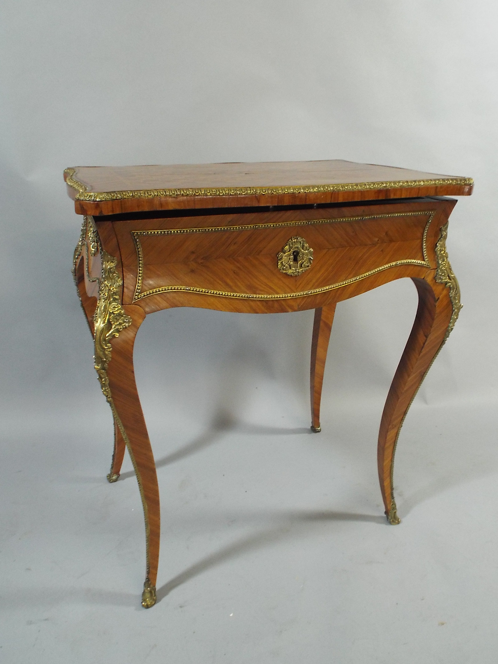 A 19th Century Kingwood Ormolu Mounted Ladies Work Table. The Hinged Lid with Inner Mirror on