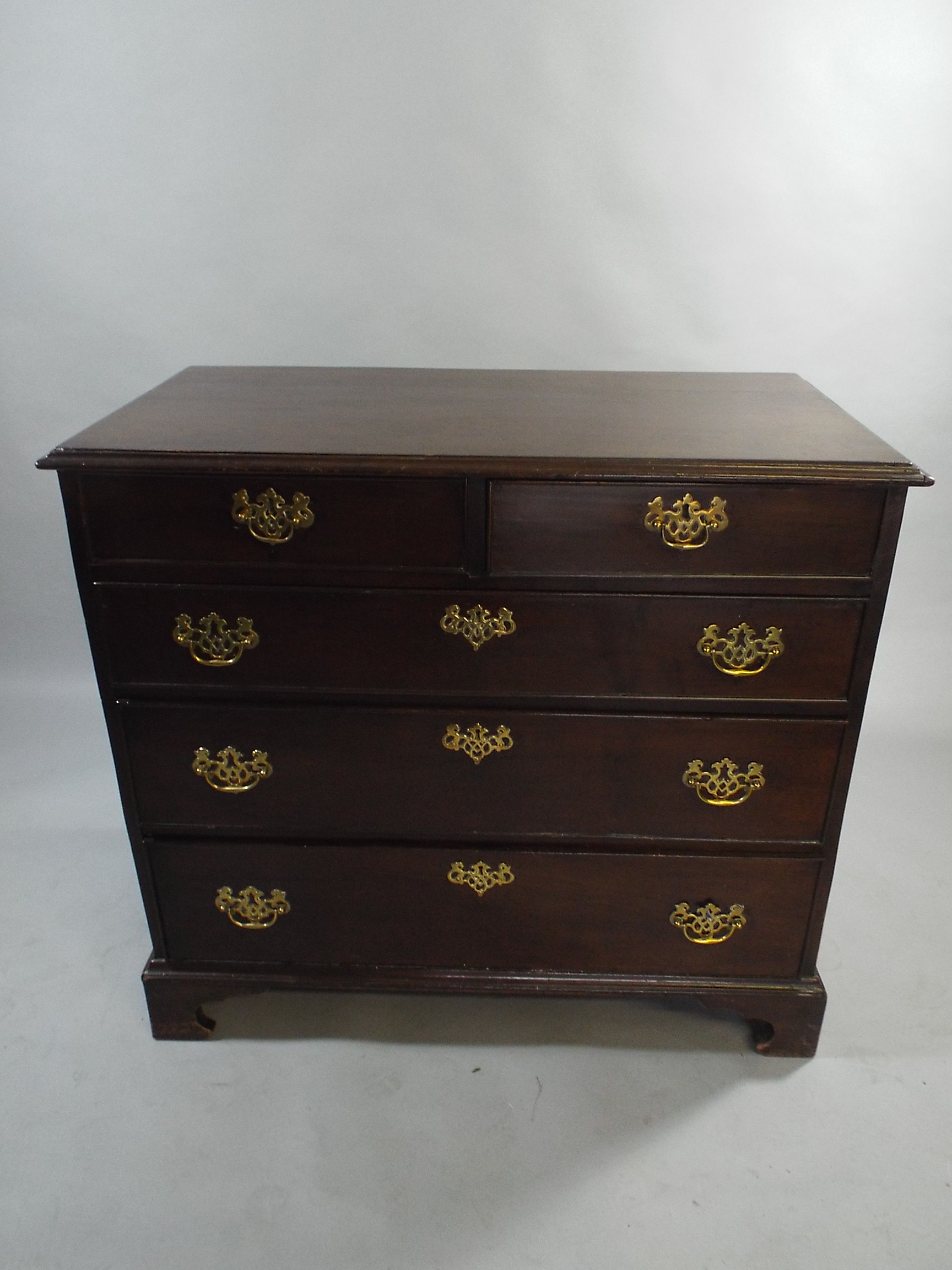 A Georgian Red Walnut Chest of Two Short and Three Graduated Long Drawers on Bracket Feet Pierced