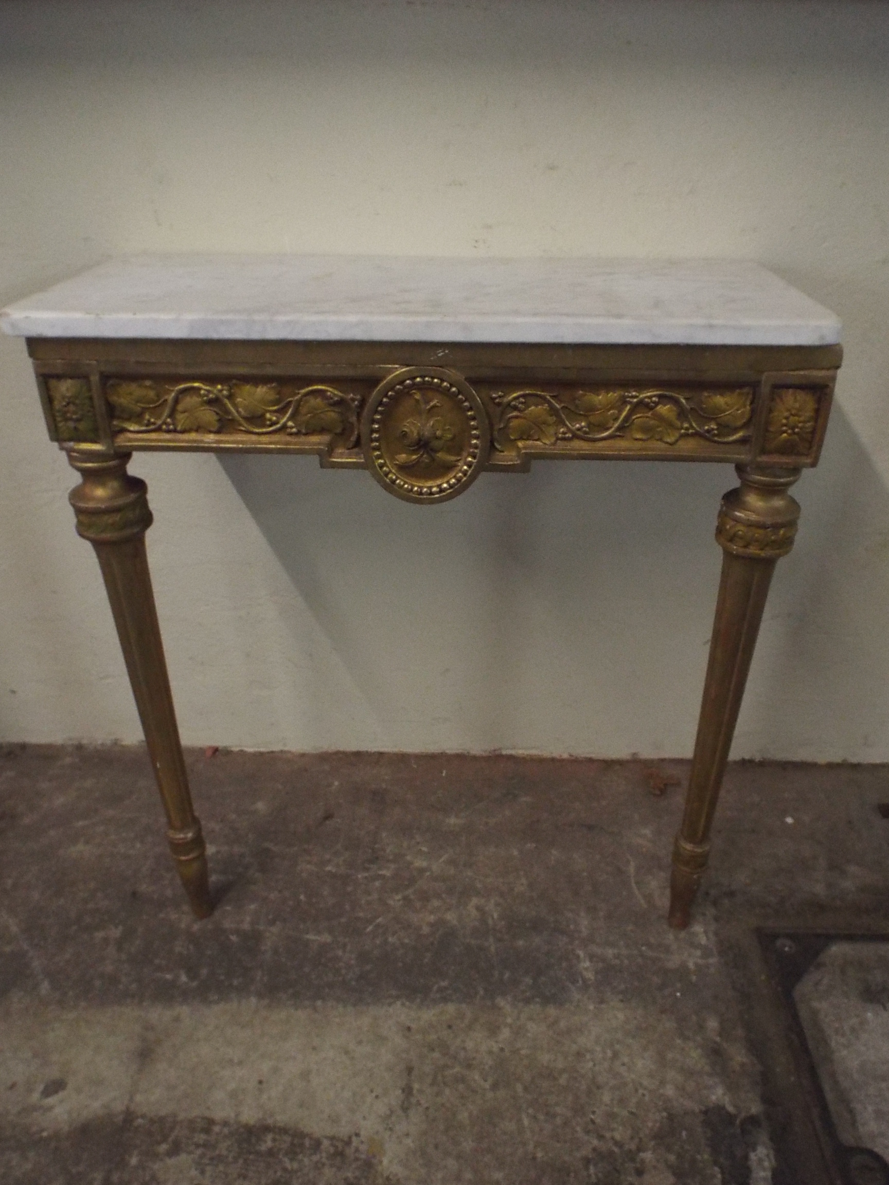 A Marble Topped Gilt Console Table with Moulded Frieze and Turned Tapering Reeded Legs.