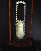 Chinese 20th Century Pale Celadon Suspended Jade Vase and Cover, the body of the vase carved with