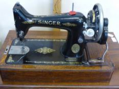 A Vintage Singer Sewing Machine, with cover.