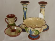 A collection of Torquay pottery including candlesticks, kettle stand, milk jug, teapot and mug.