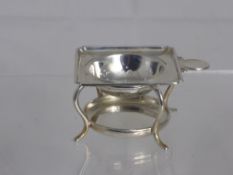 A Solid Silver Tea Strainer and Stand, together with two silver plated bottle coasters and a silver