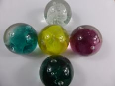 Five Caithness `Carnival` Paperweights, including green, white, red and yellow.