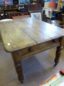 A Vintage Scrubbed Pine Kitchen Table, with a central drawer, est. 134 x 95 x 78 cms.