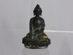 An Antique Sino-Tibetan Figure of Buddha, engraved with chasing dragons to the robe, Buddha is