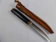 An ebony and brass skinning knife with the original sheath.
