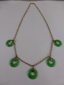 A 14 ct Gold and Jadite Necklace, the necklace set with five apple green jade discs, 40 cms, 9.9