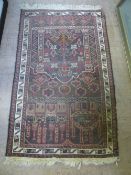 A vintage woollen rug decorated with columns and buildings in brown, beige and reds, est. 129 x 75