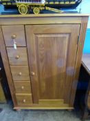 A pine cupboard having five drawers the left side, est 82 x 38 x 121 cms.