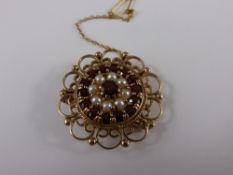 A Lady`s 9 ct Garnet and Pearl Pendant Brooch, the filigree brooch set with a circle of garnets