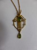 An Edwardian Peridot and Seed Pearl Drop Pendant on a 9 ct Gold Chain. Oval peridot 8.6 mm, pear