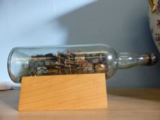 A ship in a bottle, est. length of bottle 30 cms.