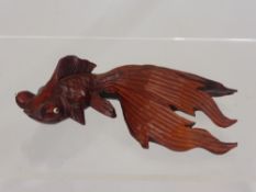 A Chinese Wood Carving of a Fantail Goldfish with glass eyes, approx 15 cms long.